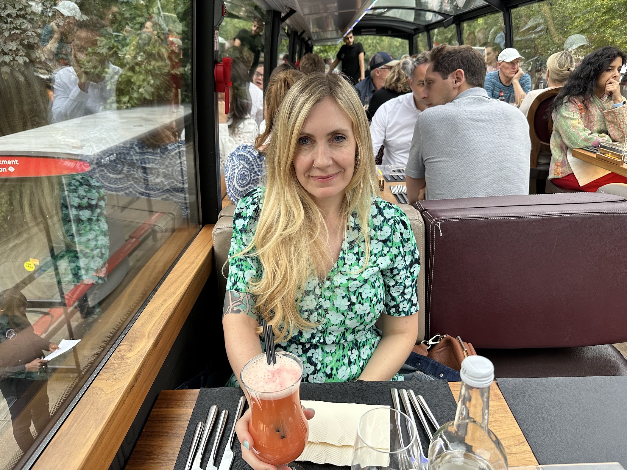 Kelly having cocktails on a fancy bus