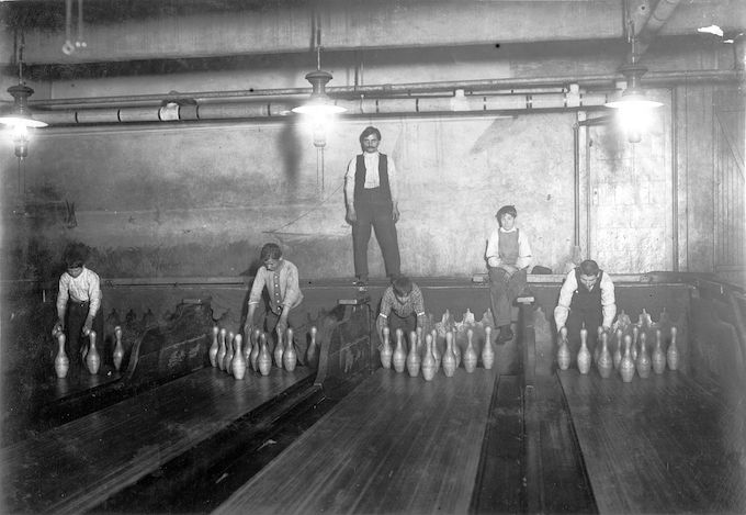 Pin boys setting up pins in the 1950s